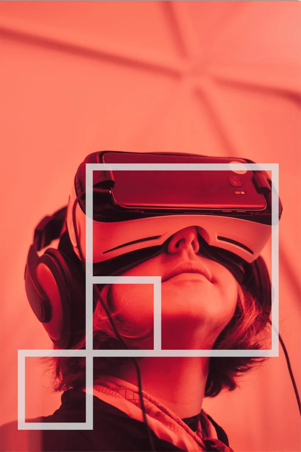 Person wearing a virtual-reality headset, bathed in coral light